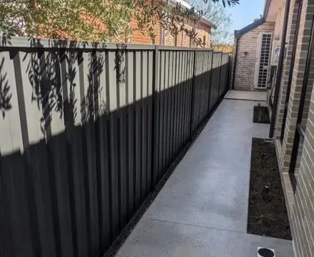 Black colorbond fence on a pathwalk